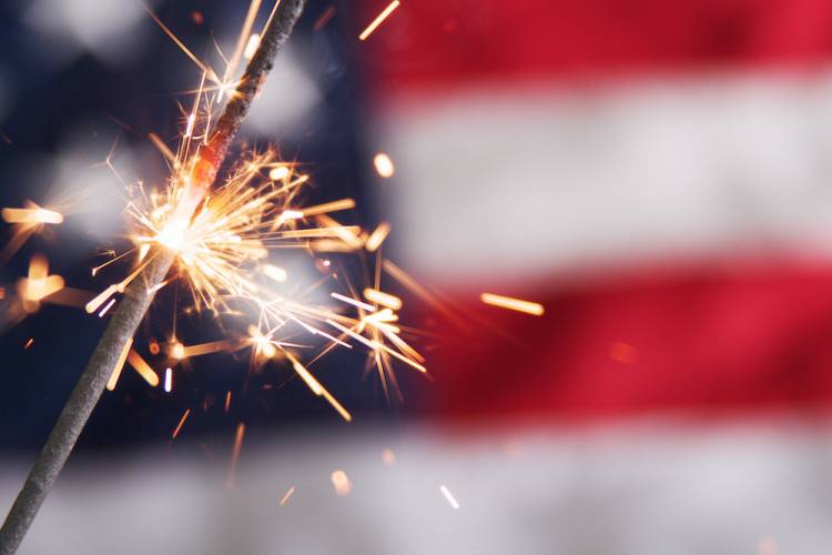 Sparkler in front of an American Flag